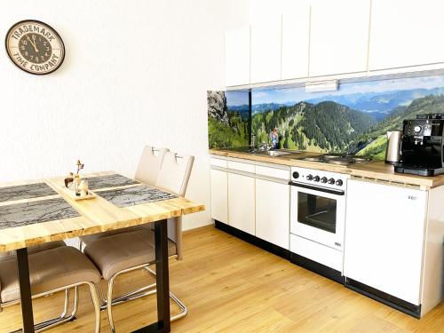 a kitchen with a table and a stove top oven at 1-Zi-Ferienwohnung Säulingsblick in Oy-Mittelberg