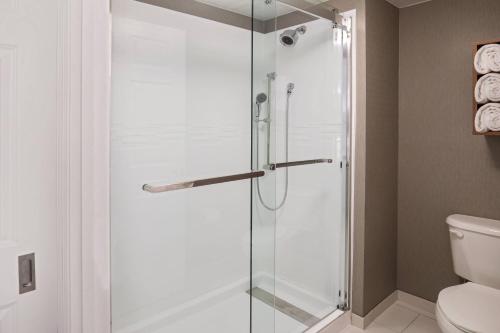 a shower with a glass door in a bathroom at Residence Inn by Marriott Boston Woburn in Woburn