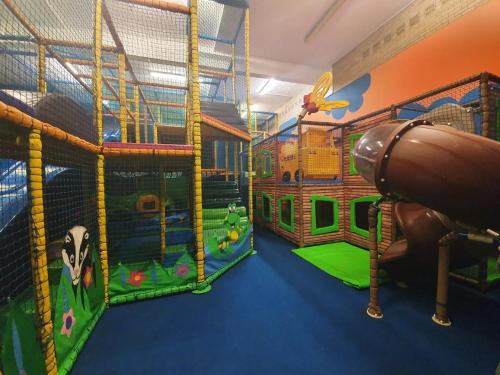 a play room with a slide and play equipment at Meadow Crest in Great Yarmouth