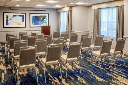 a conference room with chairs and a podium at Residence Inn by Marriott Boston Woburn in Woburn