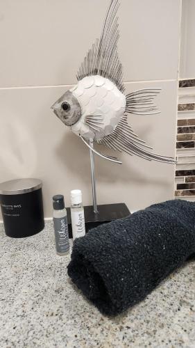 a statue of a fish on a counter with two products at Sea'scapes in Cape Town