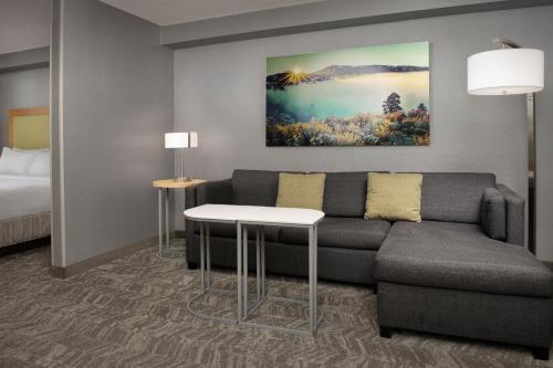 a living room with a couch and a bed at SpringHill Suites by Marriott Boise ParkCenter in Boise