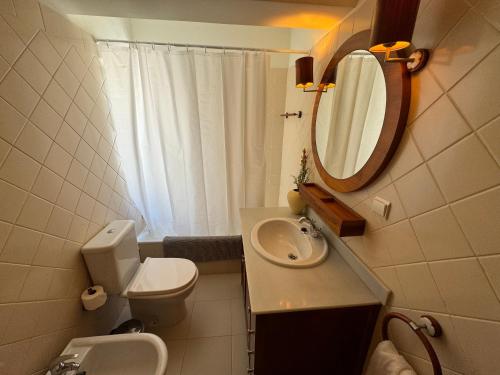 a bathroom with a sink and a toilet and a mirror at Casa da Rocha-Praia da Rocha & Spa in Portimão