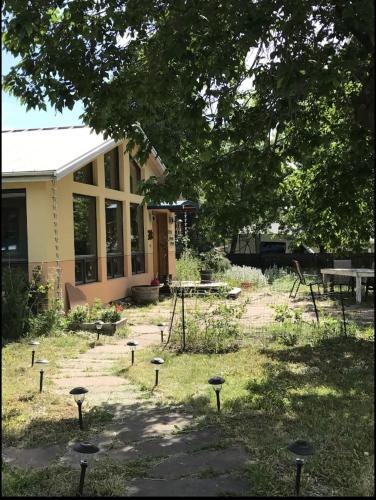 a building with a yard with a picnic table and trees at Energy-Efficient Oasis Cozy Near DT Boulder and trails in Boulder