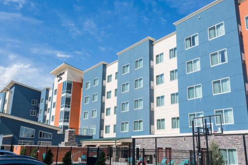 a row of apartment buildings in a city at Residence Inn by Marriott Oklahoma City Airport in Oklahoma City