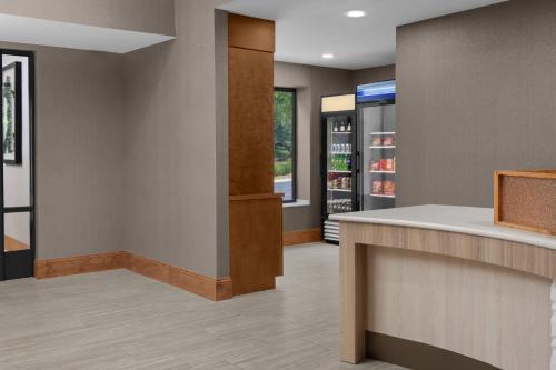 a room with a counter and a drink refrigerator at SpringHill Suites Pinehurst Southern Pines in Pinehurst