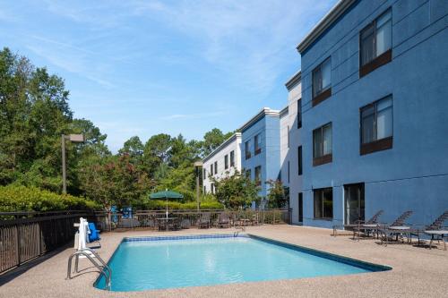 a swimming pool in front of a building at SpringHill Suites Pinehurst Southern Pines in Pinehurst
