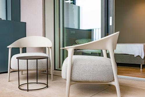 two chairs and a table in a room at Lido Vista Apartments in Lazise