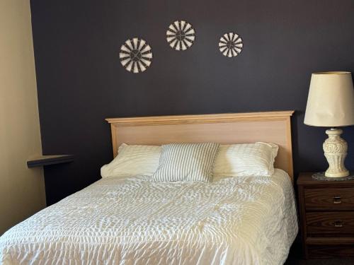 a bedroom with a bed with fourwheels on the wall at Rustic Lodge in Glasgow