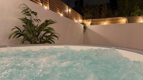a jacuzzi tub in a backyard at night at London Acton - hot tub, cinema, games & arcade in London