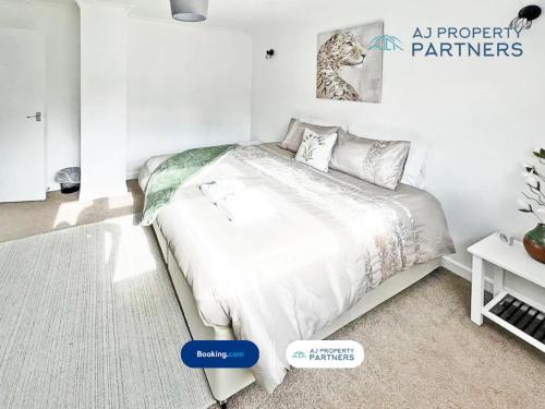 a white bedroom with a bed in a room at Premium Deal l Hill View Home l Last-Minute Offer l Cheltenham l AJ Properties l Perfect for Short or Long Stays l 4Beds 4Bedrooms in Cheltenham