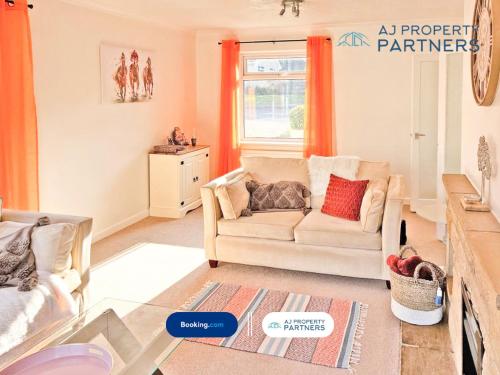 a living room with a couch and orange curtains at Premium Deal l Hill View Home l Last-Minute Offer l Cheltenham l AJ Properties l Perfect for Short or Long Stays l 4Beds 4Bedrooms in Cheltenham