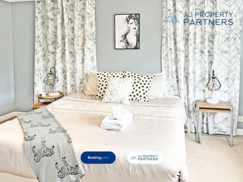 a bedroom with a bed and a window with curtains at Premium Deal l Hill View Home l Last-Minute Offer l Cheltenham l AJ Properties l Perfect for Short or Long Stays l 4Beds 4Bedrooms in Cheltenham