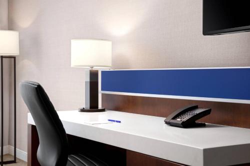 a desk with a keyboard and a phone on it at Delta Hotels by Marriott Thunder Bay in Thunder Bay