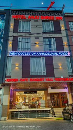 a hotel with a sign on the front of a building at Hotel Anju Shree Inn-Near Jaipur Airport Terminal 1 in Jaipur