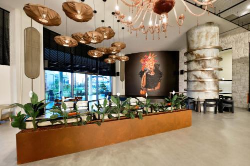 a lobby with a bunch of plants and a painting at Ethno Belek in Belek