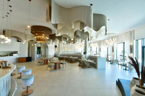 a restaurant with a large room with tables and chairs at Ethno Belek in Belek
