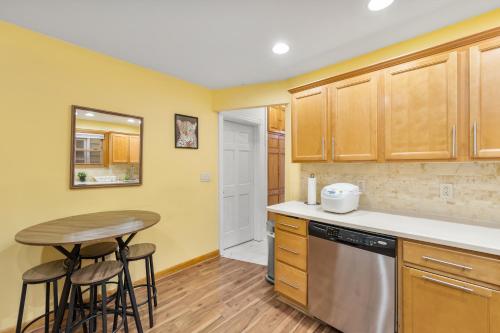 a kitchen with a table and stools in it at Epic Spa & Play Retreat NYC EWR Sleeps 30! in Bayonne