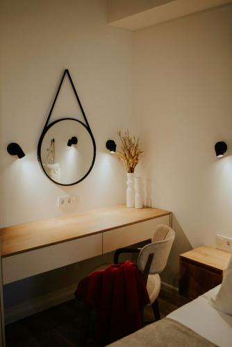 a bedroom with a mirror on the wall at Pool House in Tbilisi City