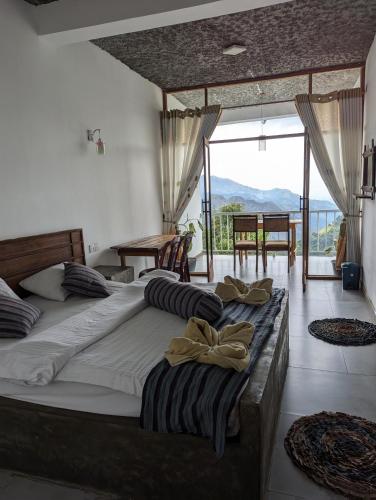 a large bed in a room with a large window at Rock Paradise Homestay in Ella