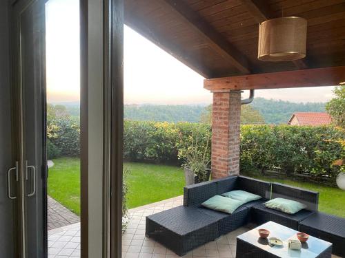 a black couch sitting on a patio with a window at La Canonica di Soglio in Camerano Casasco