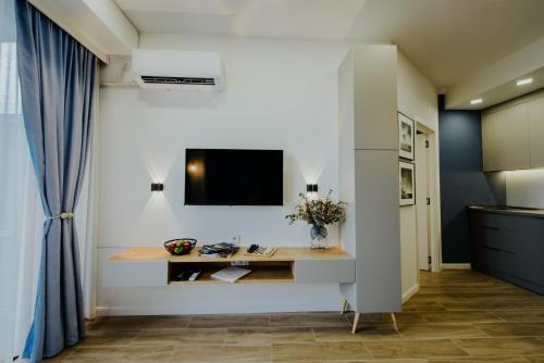 a living room with a tv on a wall at Pool House in Tbilisi City