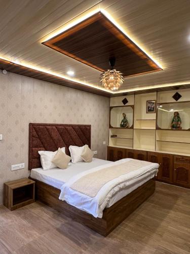 a bedroom with a large bed with a ceiling at Dolia Pahadi Stays & Cafe' in Rānīkhet