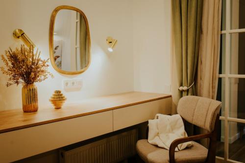 a mirror and a chair in a room at Pool House in Tbilisi City