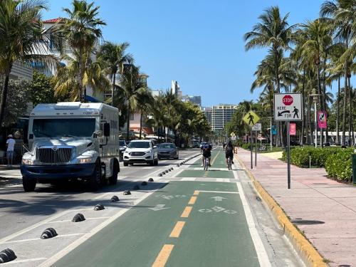a food truck driving down a street with palm trees at Ocean Drive Steps to Sea in South Beach with Free Parking in Miami Beach