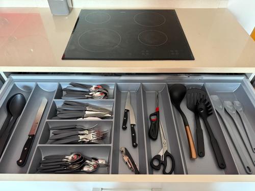 a drawer filled with utensils in a kitchen at Casa de Férias Lucena in Lourinhã