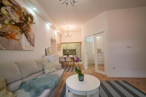 a living room with a couch and a table at Four Seasons Apartments in Sarajevo