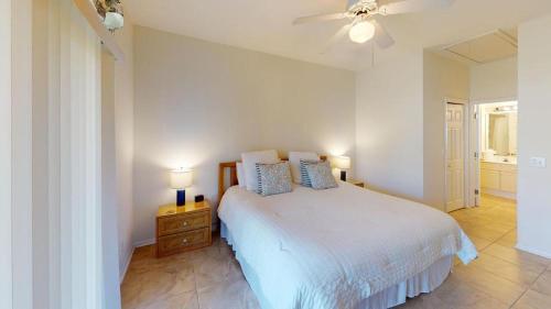a white bedroom with a bed and a ceiling fan at Beach Bum Adventure 2 Bdrm 2 Bath Scenic View in Pawleys Island