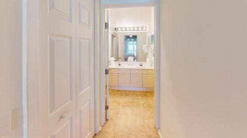 a white bathroom with a sink and a mirror at Beach Bum Adventure 2 Bdrm 2 Bath Scenic View in Pawleys Island
