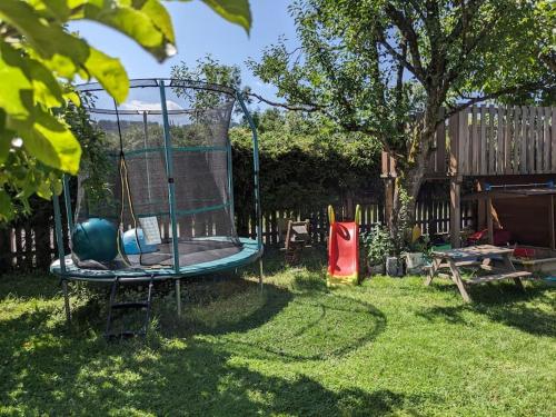 a swing set in the yard of a backyard at Schöne Wohnung mit Terrasse, Garten und-Pool in Thalgau