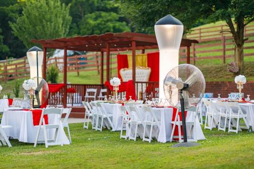 a group of tables with white chairs and a gazebo at Country Cove in Brentwood