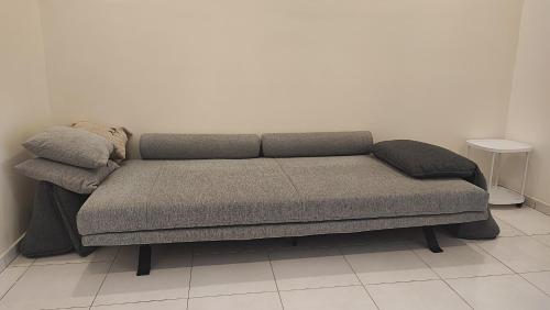 a couch with two pillows on it in a room at Minimalist Heaven Near Tmn Intan in Sungai Petani