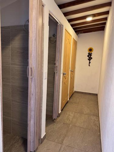 an empty hallway with two doors and a walk way at Casa Rionegro Colonial in Rionegro
