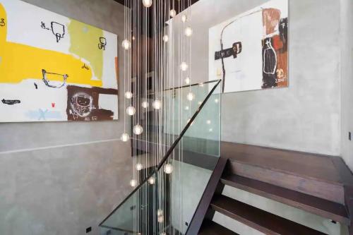 a staircase in a house with a glass railing at The Oasis Tranquil Escape in Bangkok