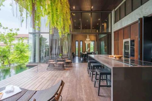 a large kitchen with a long table and chairs at The Oasis Tranquil Escape in Bangkok