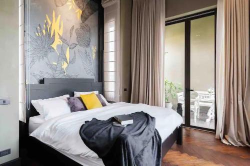 a bedroom with a large bed and a large window at The Oasis Tranquil Escape in Bangkok