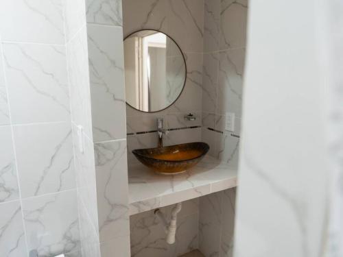 a bathroom with a wooden sink and a mirror at Dúplex Nuevo - Salta Capital in Salta