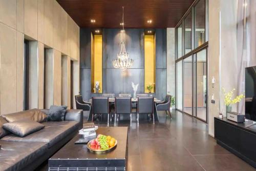 a living room with a couch and a table at The Oasis Tranquil Escape in Bangkok