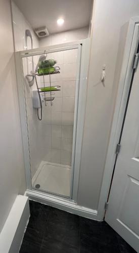 a shower with a glass door in a bathroom at Cosy Penthouse suite happily sleeps up to five in Halifax