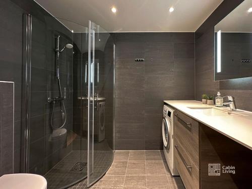 a bathroom with a shower and a toilet and a sink at Modern Apartment in Trysil Lodge Ski in out in Trysil