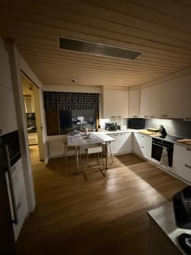 a kitchen with a table and chairs in it at Riverside Villa Aurora in Rovaniemi