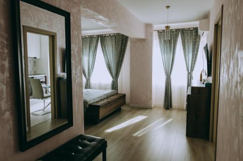 a bedroom with a mirror and a bed in it at Dina Lux Iasi Apartment in Iaşi