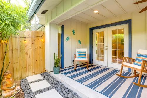 a patio with a table and chairs on a house at Jupiter Cottage with Patio, Gas Grill and Fire Pit! in Jupiter