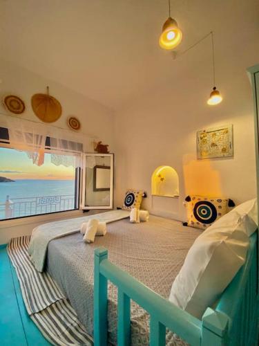 a bedroom with a bed with a view of the ocean at Kalimera Apartment in Kalymnos
