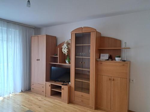 a large wooden cabinet with a television in a room at Welcoming apartment in Anykščiai