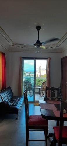 a living room with a couch and a table with a view at La casa de Marcel et Nathalie in Baní
